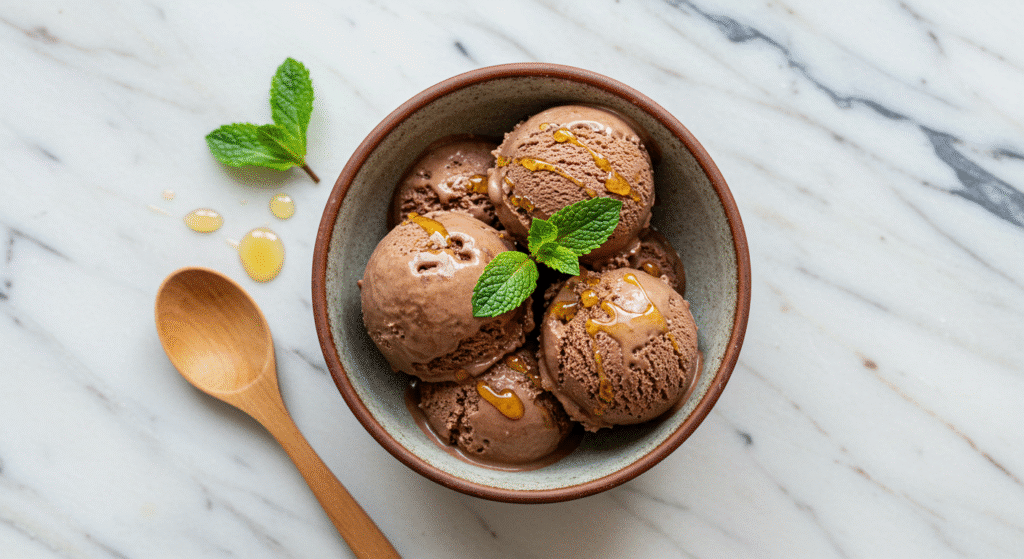 Cottage cheese chocolate ice cream served in ceramic bowl with mint garnish