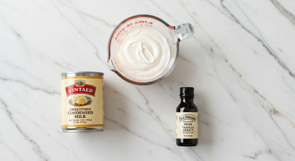 Three ingredients for homemade ice cream - condensed milk, heavy cream, vanilla extract